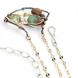 A dark sterling silver pendant necklace with gold-filled chain, featuring a turquoise drop, faceted green amethyst coin, and a golden sheen faceted moonstone in bronze wire