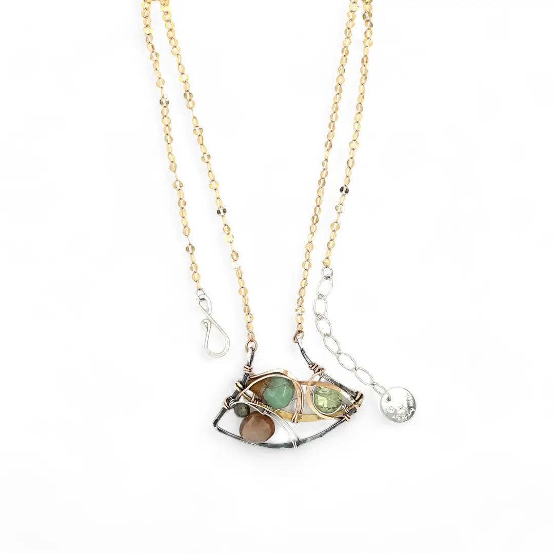 A dark sterling silver pendant necklace with gold-filled chain, featuring a turquoise drop, faceted green amethyst coin, and a golden sheen faceted moonstone in bronze wire