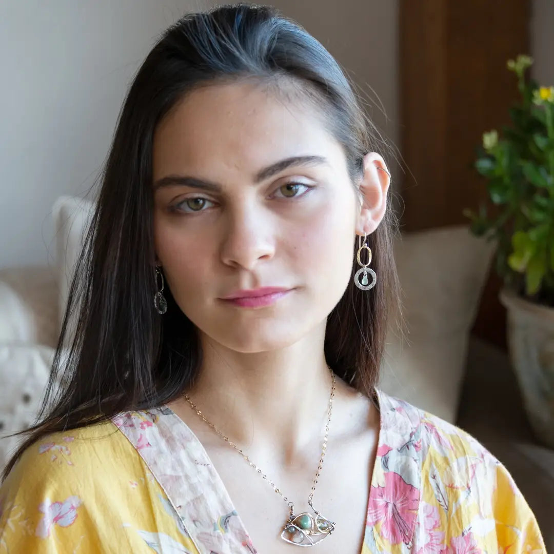A dark sterling silver pendant necklace with gold-filled chain, featuring a turquoise drop, faceted green amethyst coin, and a golden sheen faceted moonstone in bronze wire
