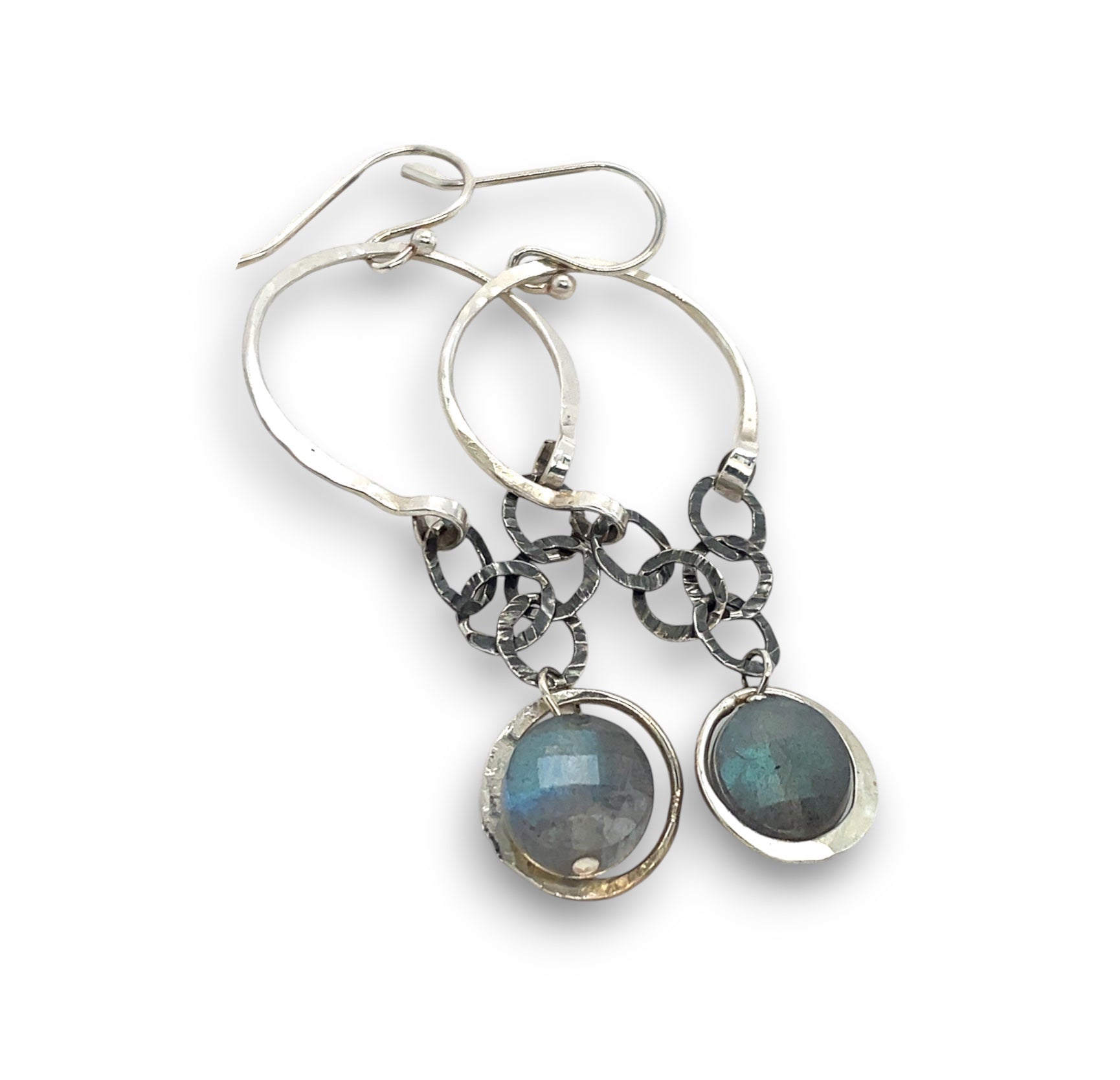 A pair of sterling silver hoop earrings with labradorite faceted coins inside mini sterling silver hammered rings, suspended from oxidized crinkle chain.