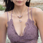 A sterling silver hammered necklace with gold-filled accents, featuring a faceted amethyst gemstone pendant and an adjustable chain with a handmade signature clasp.