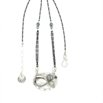 A sterling silver necklace with a pendant featuring fresh water pearl, moonstone, and pyrite gemstones, complemented by an oxidized sterling silver satellite chain.