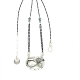 A sterling silver necklace with a pendant featuring fresh water pearl, moonstone, and pyrite gemstones, complemented by an oxidized sterling silver satellite chain.