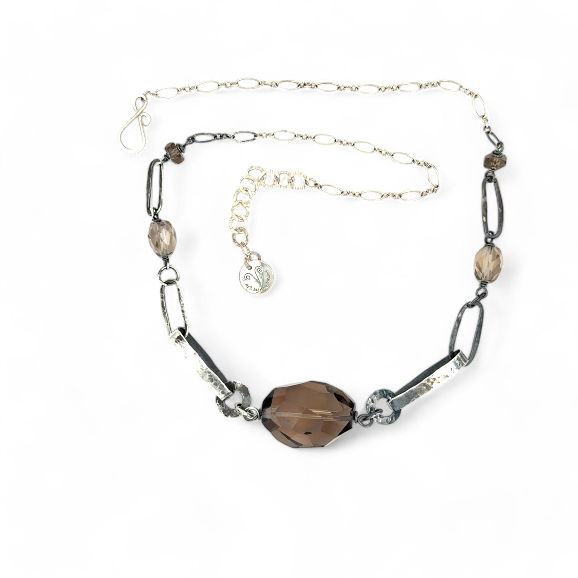 An adjustable sterling silver chain necklace with smokey quartz faceted gemstone nuggets and handmade sterling silver links with leaf patterns.