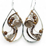 A pair of handcrafted sterling silver drop earrings with swirling bronze curls, featuring smokey quartz gemstones and freshwater pearls and pyrite