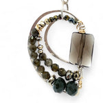 A pair of sterling silver earrings featuring smokey quartz, olive cat's eye micro-faceted gemstones, and pyrite gemstones on gold filled wire