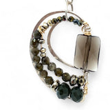 A pair of sterling silver earrings featuring smokey quartz, olive cat's eye micro-faceted gemstones, and pyrite gemstones on gold filled wire