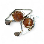 Rust colored striped agate coin gemstones are triple wrapped in gold filled wire on oxidized sterling silver diamond earrings with a smokey quartz smooth teardrop dangle