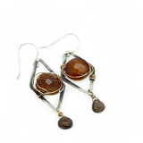 Rust colored striped agate coin gemstones are triple wrapped in gold filled wire on oxidized sterling silver diamond earrings with a smokey quartz smooth teardrop dangle