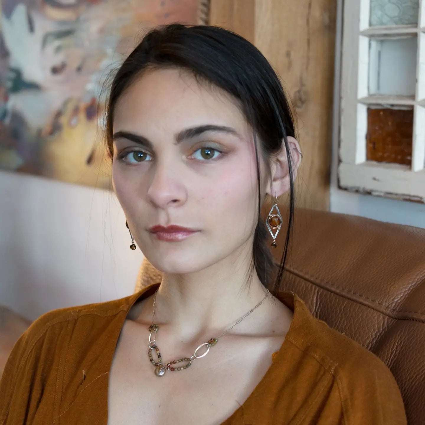 Rust colored striped agate coin gemstones are triple wrapped in gold filled wire on oxidized sterling silver diamond earrings with a smokey quartz smooth teardrop dangle