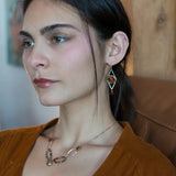 Rust colored striped agate coin gemstones are triple wrapped in gold filled wire on oxidized sterling silver diamond earrings with a smokey quartz smooth teardrop dangle