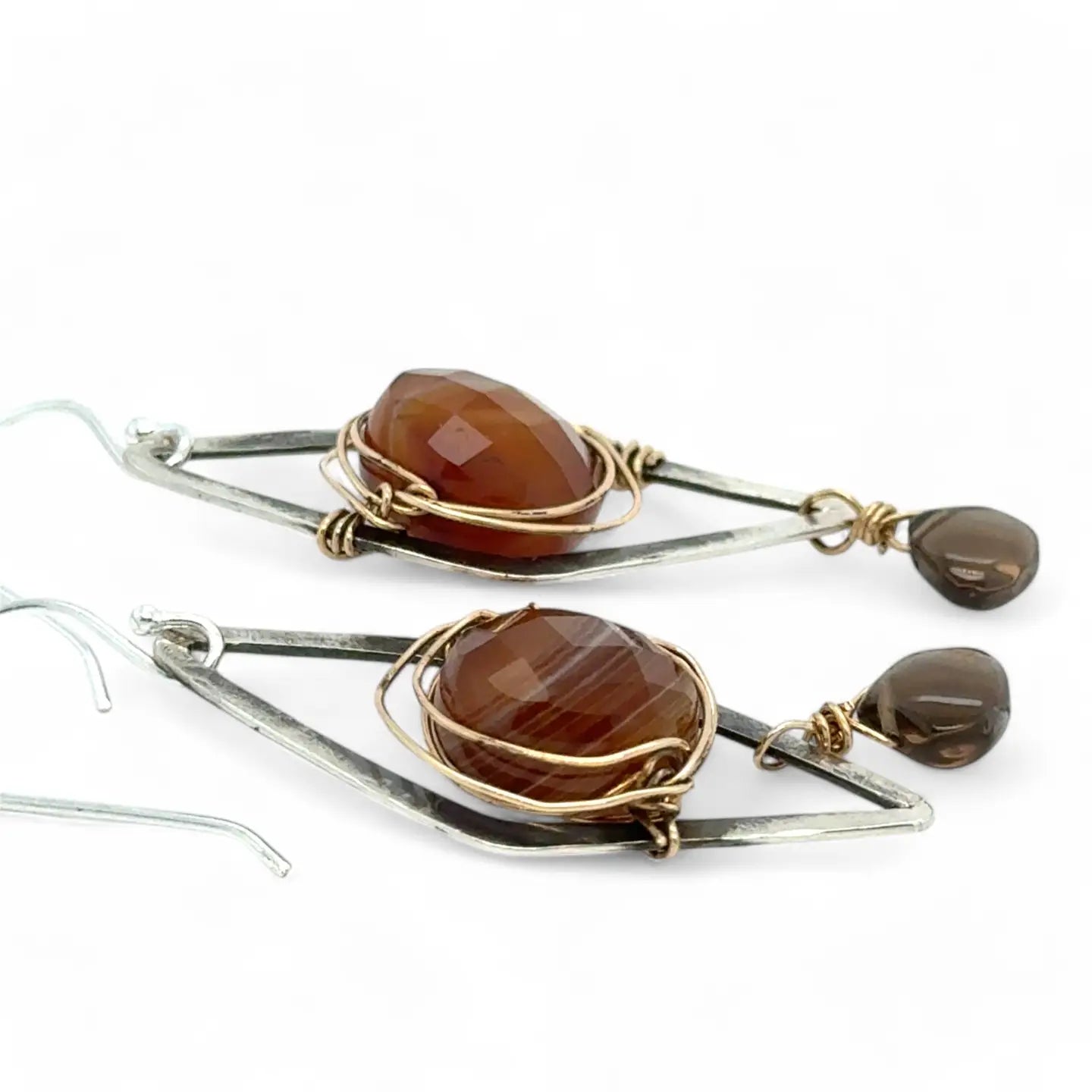 Rust colored striped agate coin gemstones are triple wrapped in gold filled wire on oxidized sterling silver diamond earrings with a smokey quartz smooth teardrop dangle
