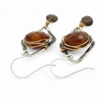 Rust colored striped agate coin gemstones are triple wrapped in gold filled wire on oxidized sterling silver diamond earrings with a smokey quartz smooth teardrop dangle