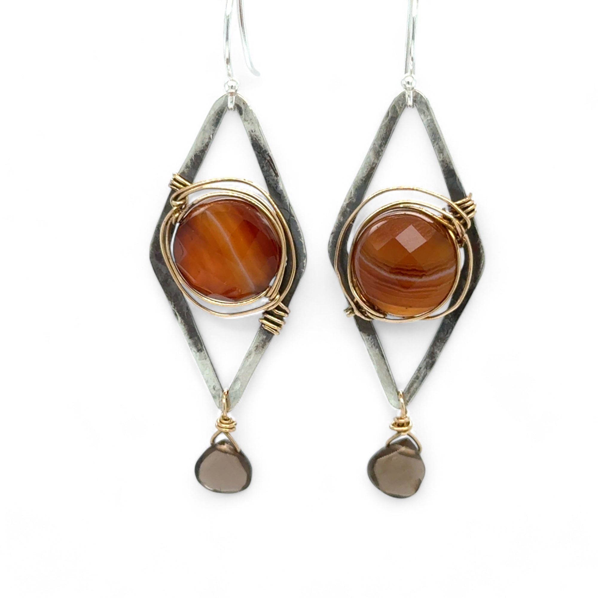 Rust colored striped agate coin gemstones are triple wrapped in gold filled wire on oxidized sterling silver diamond earrings with a smokey quartz smooth teardrop dangle