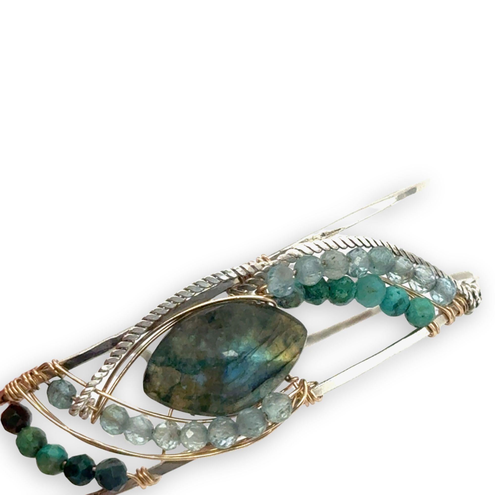Apatite and chrysocolla gemstones surround a labradorite marquise gemstones held in gold filled and oxidized sterling silver twist wire inside a sterling silver handmade cuff bracelet