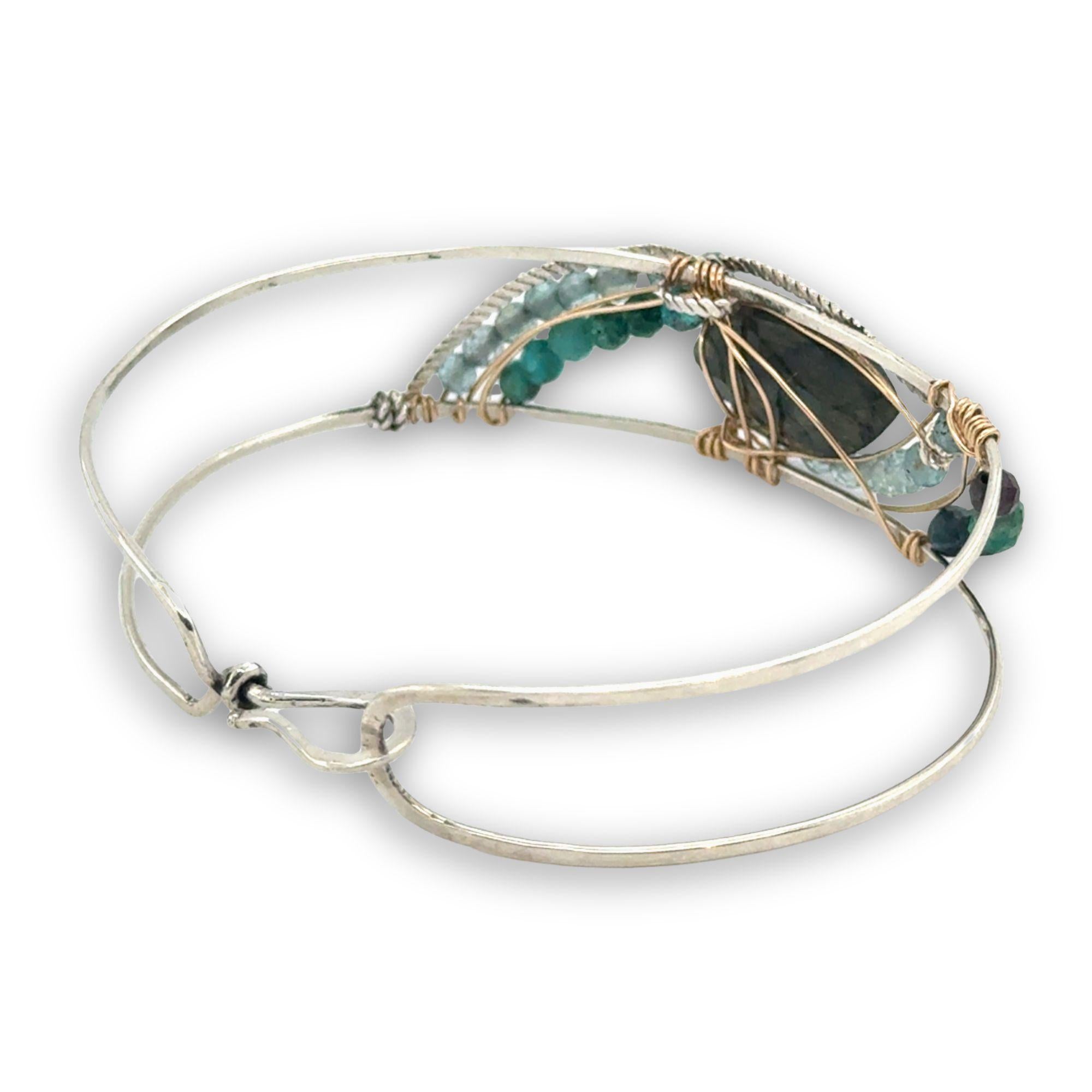 Apatite and chrysocolla gemstones surround a labradorite marquise gemstones held in gold filled and oxidized sterling silver twist wire inside a sterling silver handmade cuff bracelet