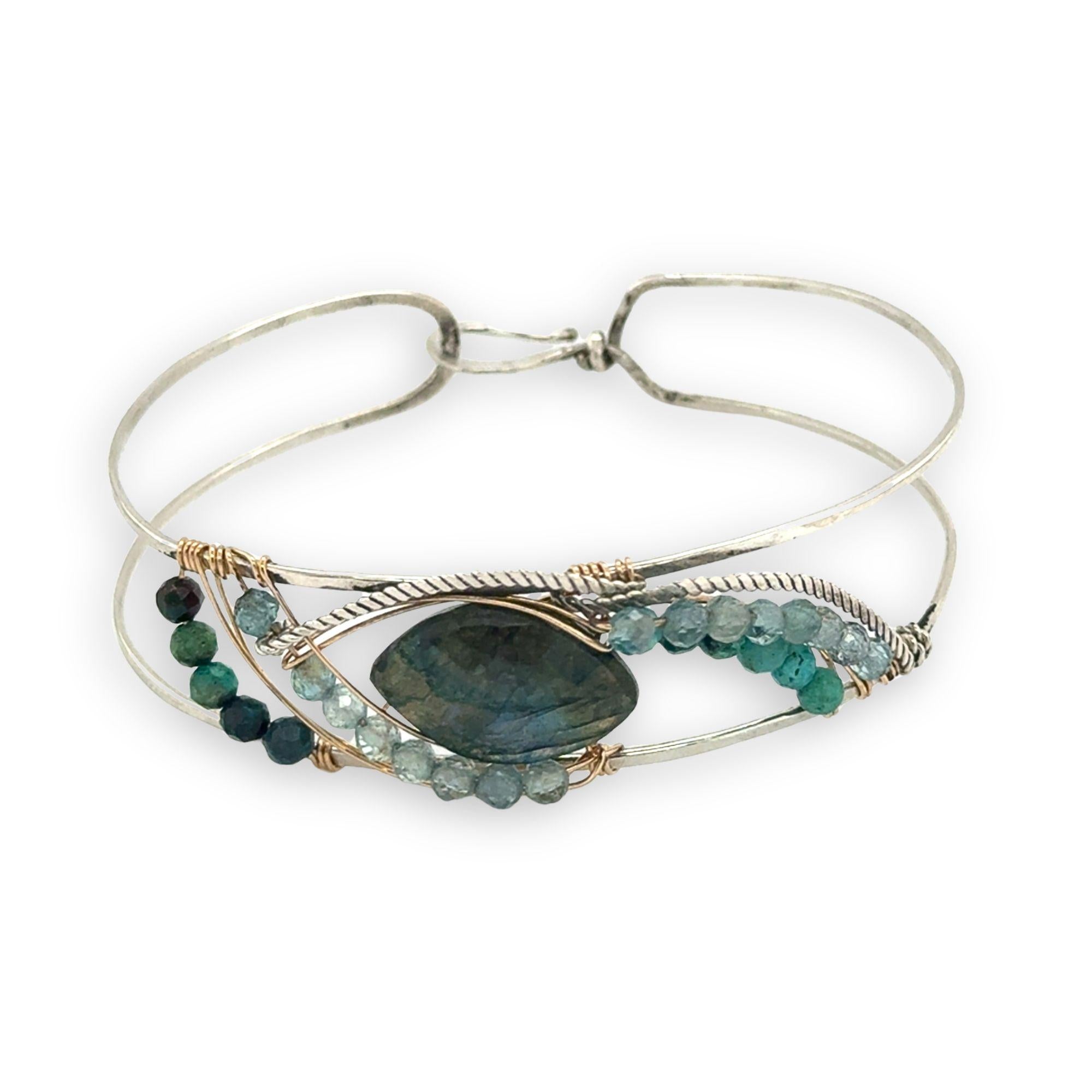 Apatite and chrysocolla gemstones surround a labradorite marquise gemstones held in gold filled and oxidized sterling silver twist wire inside a sterling silver handmade cuff bracelet