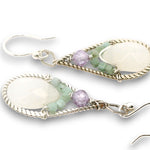 Sterling silver twisted wire drop earrings with white jade drops, lavender cubic zirconia and emerald cube gemstones on a textured link