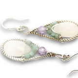 Sterling silver twisted wire drop earrings with white jade drops, lavender cubic zirconia and emerald cube gemstones on a textured link
