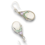 Sterling silver twisted wire drop earrings with white jade drops, lavender cubic zirconia and emerald cube gemstones on a textured link