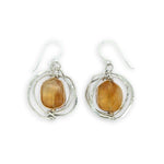 Sterling silver hammered knot earrings holding citrine nugget gemstones