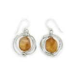 Sterling silver hammered knot earrings holding citrine nugget gemstones