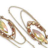 iridescent peach double pointed crystal sits in an open hammered bronze point lined with champagne fresh water pearl and sunstone gemstones, hanging from citrine faceted orbs, accented with gold filled chain
