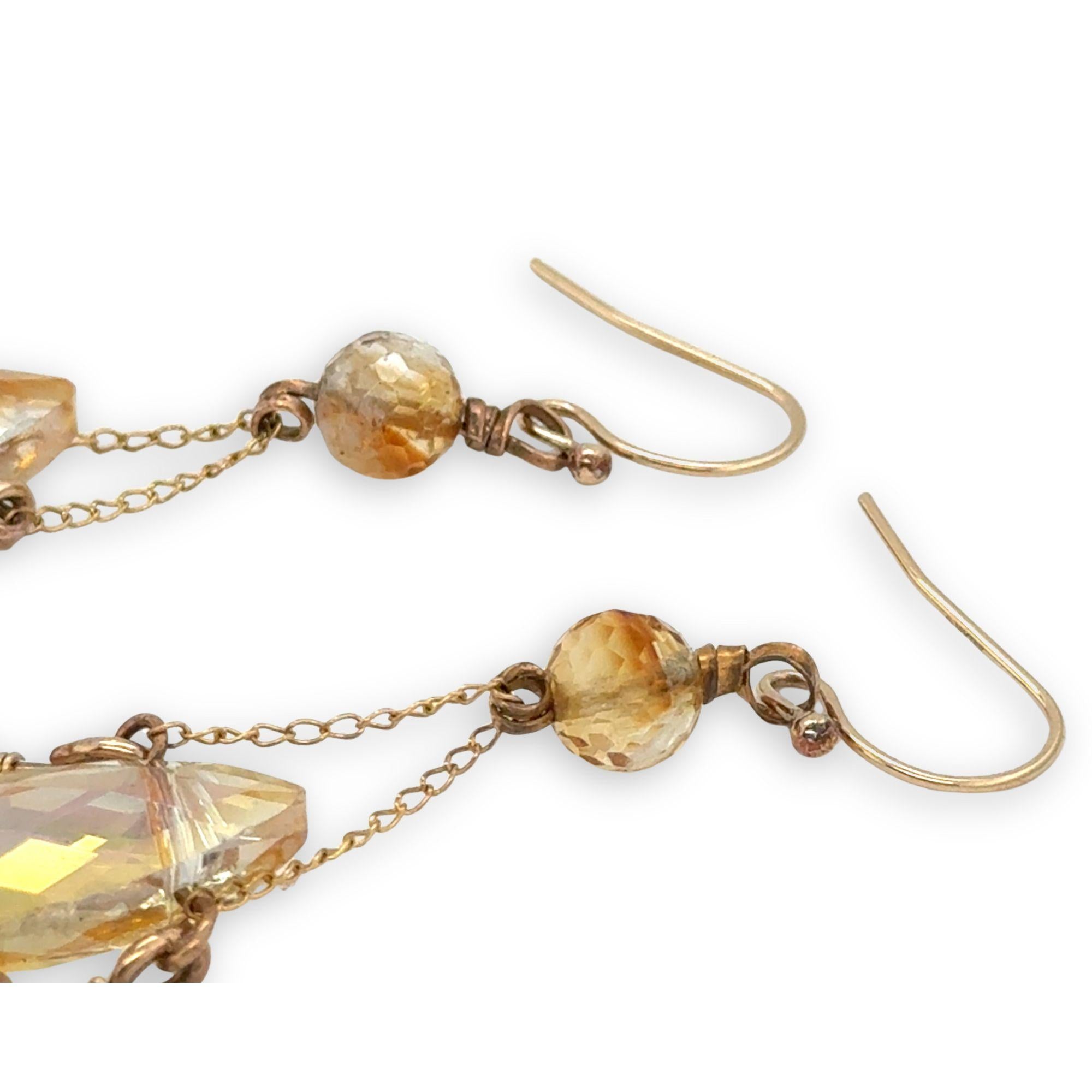 iridescent peach double pointed crystal sits in an open hammered bronze point lined with champagne fresh water pearl and sunstone gemstones, hanging from citrine faceted orbs, accented with gold filled chain