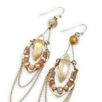 iridescent peach double pointed crystal sits in an open hammered bronze point lined with champagne fresh water pearl and sunstone gemstones, hanging from citrine faceted orbs, accented with gold filled chain