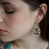 Smooth labradorite flashy gemstones surrounded by pyrite and blue purple crystals wrapped in brass twist on sterling silver drop earrings