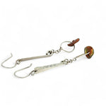 Handmade hammered sterling silver bar earrings with a rust orange colored fresh water pearl dangle