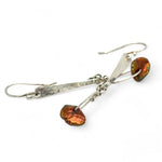 Handmade hammered sterling silver bar earrings with a rust orange colored fresh water pearl dangle