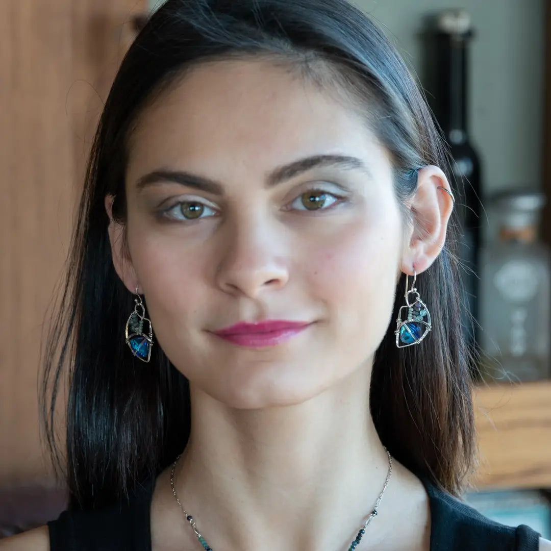 A pair of sterling silver earrings with blue crystal teardrops, apatite, crystal, and sodalite gemstones