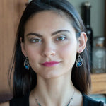 A pair of sterling silver earrings with blue crystal teardrops, apatite, crystal, and sodalite gemstones