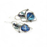 A pair of sterling silver earrings with blue crystal teardrops, apatite, crystal, and sodalite gemstones