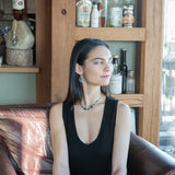 A pair of sterling silver earrings with blue crystal teardrops, apatite, crystal, and sodalite gemstones