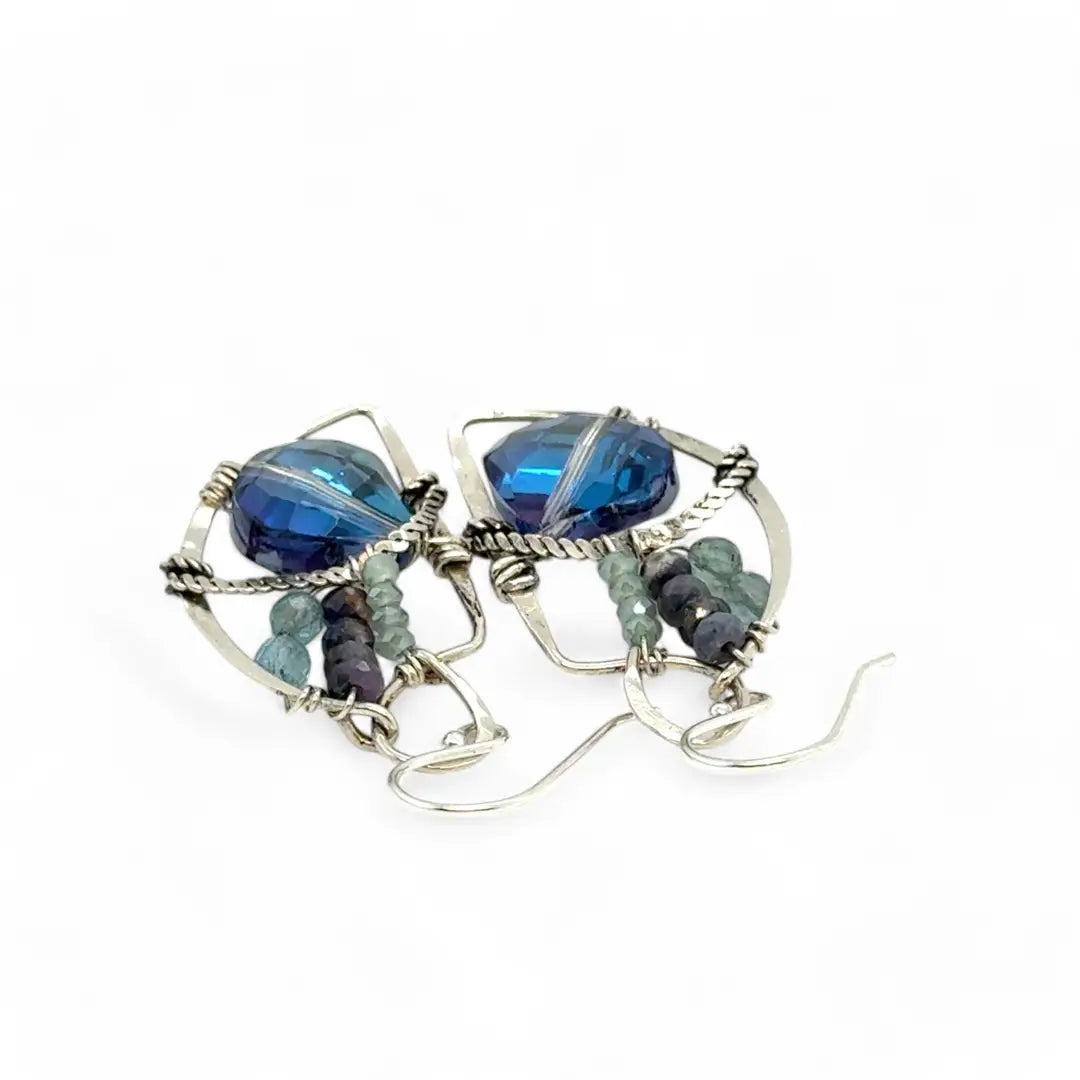 A pair of sterling silver earrings with blue crystal teardrops, apatite, crystal, and sodalite gemstones