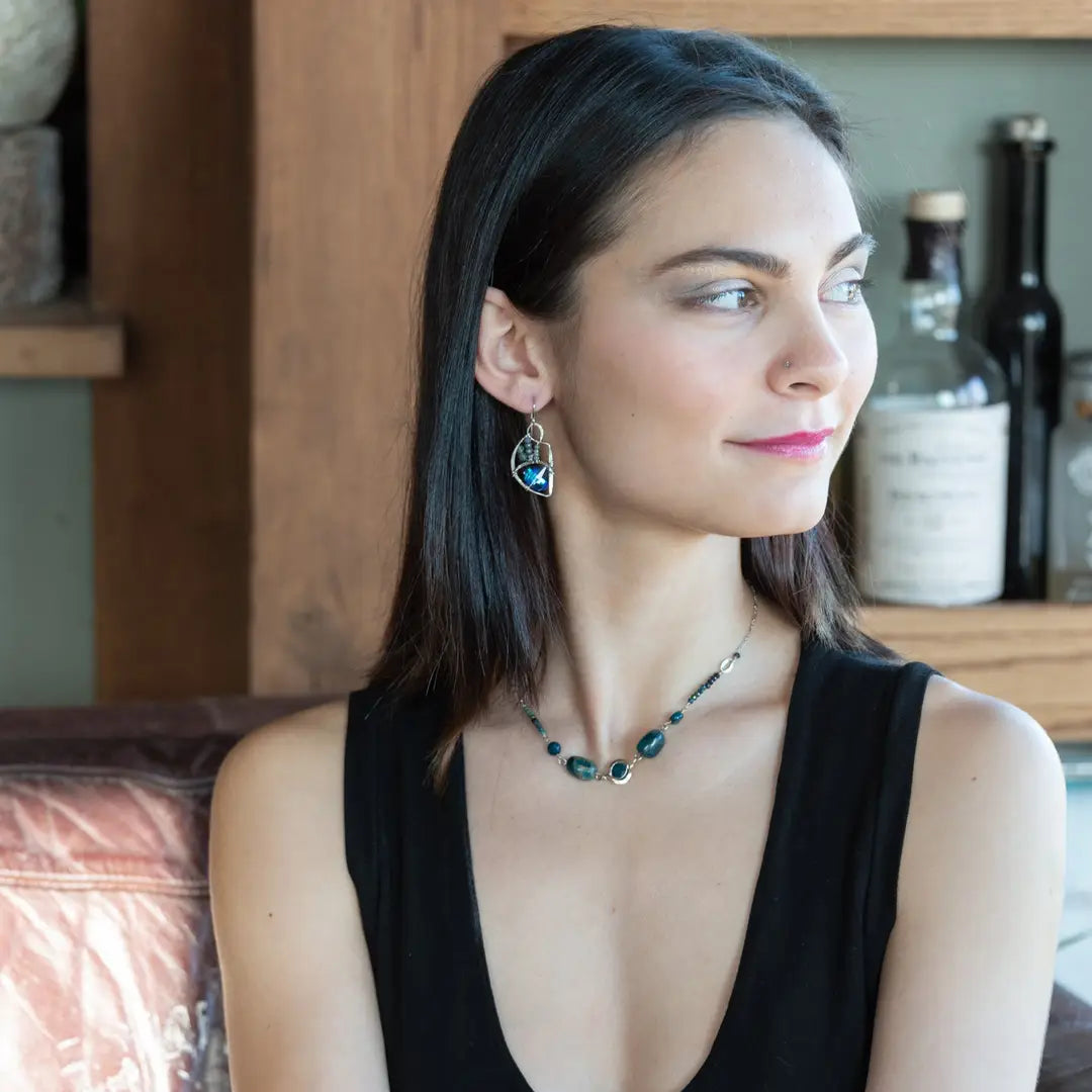 A pair of sterling silver earrings with blue crystal teardrops, apatite, crystal, and sodalite gemstones