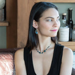 A pair of sterling silver earrings with blue crystal teardrops, apatite, crystal, and sodalite gemstones