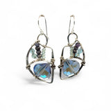 A pair of sterling silver earrings with blue crystal teardrops, apatite, crystal, and sodalite gemstones