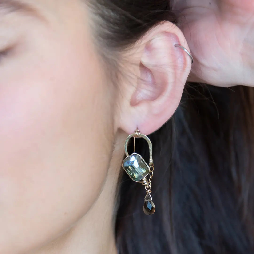 Muted moss green crystal tile built into a brass arch earring wrapped in gold filled wire with a smokey quartz faceted drop dangle and built in gold filled earring hooks that wear like a post earring