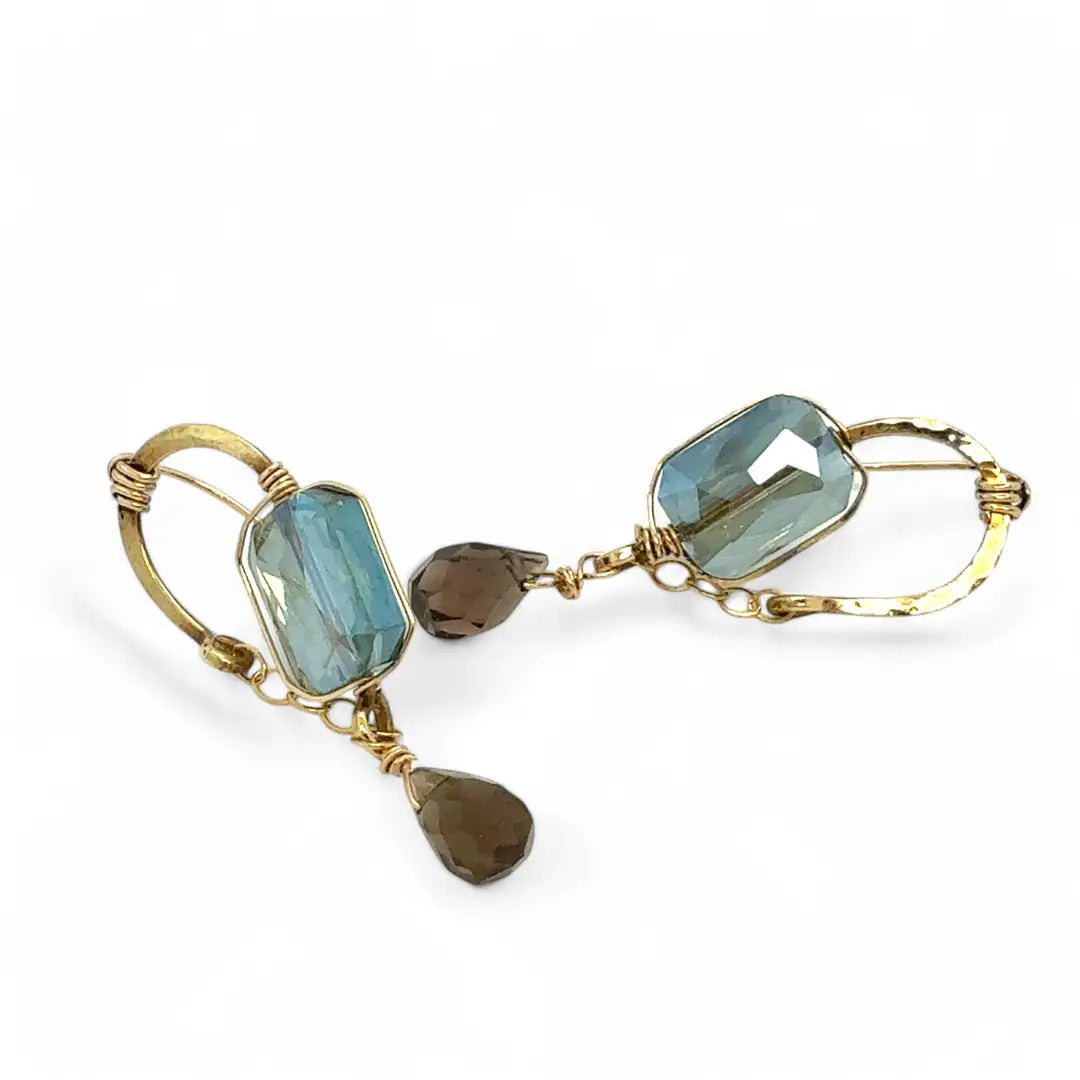 Muted moss green crystal tile built into a brass arch earring wrapped in gold filled wire with a smokey quartz faceted drop dangle and built in gold filled earring hooks that wear like a post earring