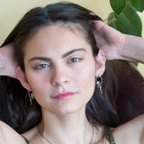 Muted moss green crystal tile built into a brass arch earring wrapped in gold filled wire with a smokey quartz faceted drop dangle and built in gold filled earring hooks that wear like a post earring