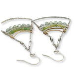 Large sterling silver fan shaped earrings decorated with gaspeite and jade faceted gemstones, brass wire, and sterling silver twist wire