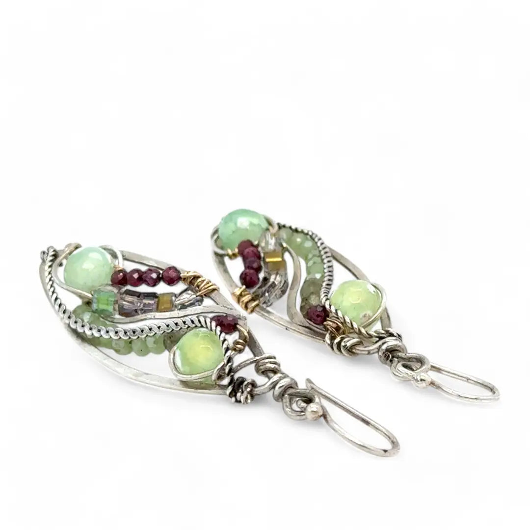 A pair of sterling silver sprout marquise earrings featuring glowing green fire agate, faceted pink garnet, and green kyanite gemstones, with braided oxidized sterling silver veins and silver French hooks.