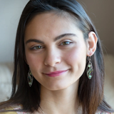 A pair of sterling silver sprout marquise earrings featuring glowing green fire agate, faceted pink garnet, and green kyanite gemstones, with braided oxidized sterling silver veins and silver French hooks.