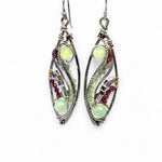 A pair of sterling silver sprout marquise earrings featuring glowing green fire agate, faceted pink garnet, and green kyanite gemstones, with braided oxidized sterling silver veins and silver French hooks.