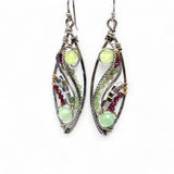 A pair of sterling silver sprout marquise earrings featuring glowing green fire agate, faceted pink garnet, and green kyanite gemstones, with braided oxidized sterling silver veins and silver French hooks.