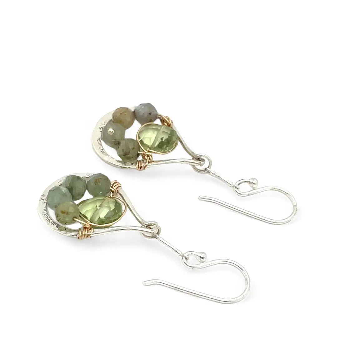 A pair of sterling silver drop earrings with faceted green kyanite gemstones and green amethyst coins, held on bar chain stems.