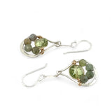 A pair of sterling silver drop earrings with faceted green kyanite gemstones and green amethyst coins, held on bar chain stems.